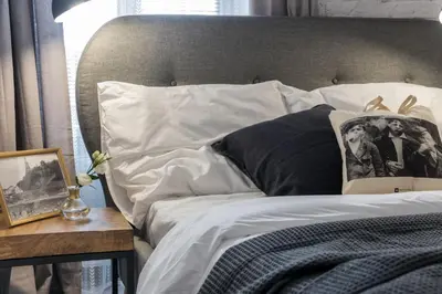a bed with white sheets and a picture on it at Bożego Ciała by Homeprime in Kraków