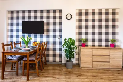 a dining room with a table and chairs and a tv at ENERGYLANDIA Zator Apartament Asia in Zator