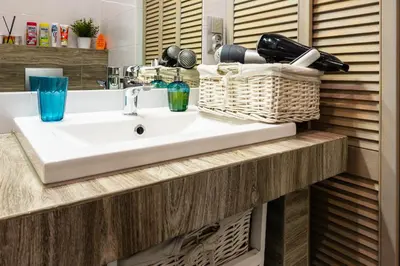 a bathroom with a white sink and a counter at ENERGYLANDIA Zator Apartament Asia in Zator