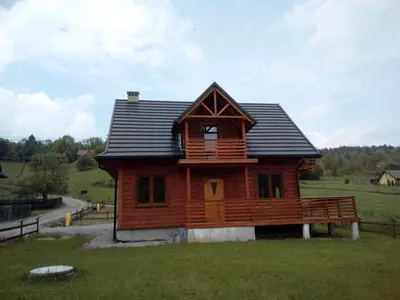 a room with two beds in a wooden room at Słoneczne Chaty pod Sonami Kasina Wielka in Kasina Wielka