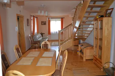 a wooden table and a bench and a table and a wooden cart at Słoneczne Chaty pod Sonami Kasina Wielka in Kasina Wielka