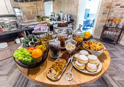 a table with a bunch of food on it at Aparthotel Rakowicka Residence in Kraków