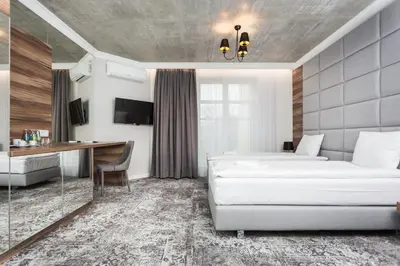 a hotel room with a bed and a desk at Aparthotel Rakowicka Residence in Kraków