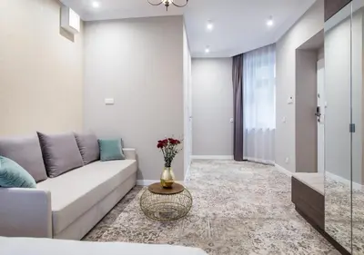 a living room with a couch and a table at Aparthotel Rakowicka Residence in Kraków