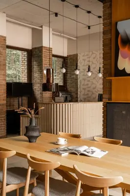 a wooden table and chairs in a room at Forest Hotel in Kraków