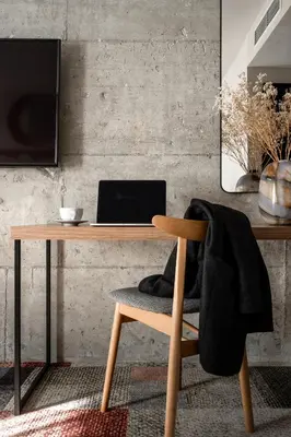 a wooden desk with a laptop and a chair at Forest Hotel in Kraków