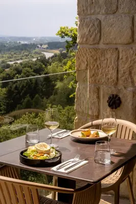 a table with two plates of food and wine glasses at Forest Hotel in Kraków