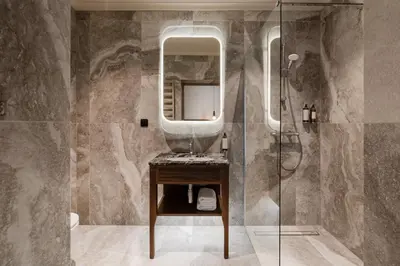 a bathroom with a sink and a mirror at Forest Hotel in Kraków