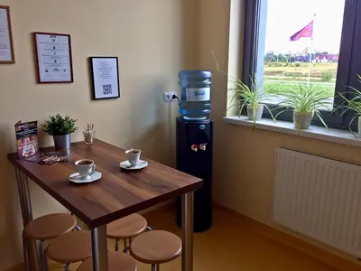 a small table and a water cooler in a room at 3Rooms in Kraków