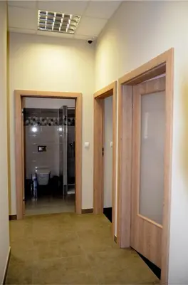 a hallway with two doors and a bathroom at 3Rooms in Kraków