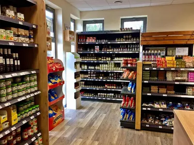 a store aisle with lots of products on display at 3Rooms in Kraków