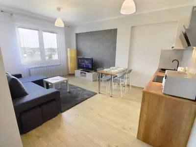 a living room with a couch and a table at Apartament Korazone ZATOR in Zator