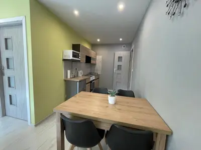 a dining room table and chairs in a kitchen at Country Rooms in Bachowice