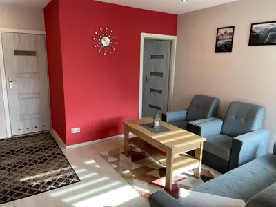 a living room with two chairs and a table at Country Rooms in Bachowice