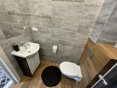 a bathroom with a toilet and a sink at Country Rooms in Bachowice