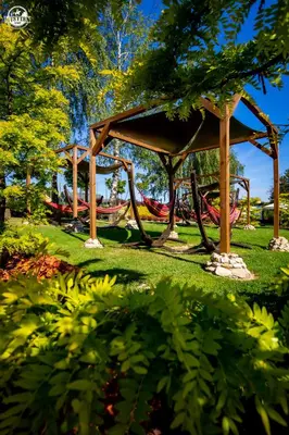 a gazebo with a playground in a park at Western Camp Resort in Zator