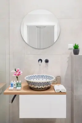 a bathroom with a bowl sink and a mirror at STRADOMSKA 2 APARTMENTS in Kraków