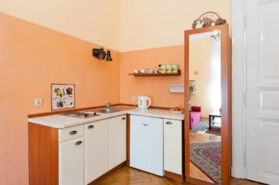 a small kitchen with a sink and a mirror at Apartamenty Pod Aniołami in Kraków