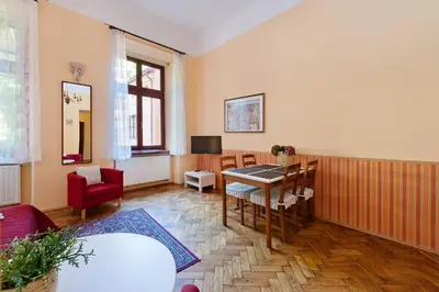 a living room with a table and chairs at Apartamenty Pod Aniołami in Kraków