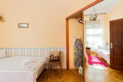 a bedroom with a bed and a mirror at Apartamenty Pod Aniołami in Kraków