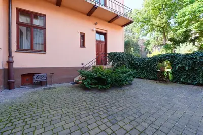a house with a brick patio in front of it at Apartamenty Pod Aniołami in Kraków