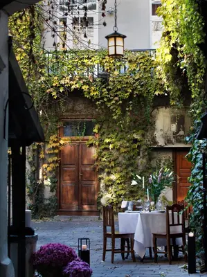 a table and chairs in front of a building at Antique Apartments Old Town in Kraków