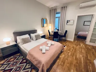 a bedroom with a bed with two towels on it at Antique Apartments Old Town in Kraków