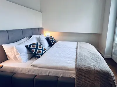 a bedroom with a large bed with pillows on it at Antique Apartments Old Town in Kraków