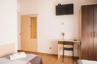 a bedroom with a desk and a bed and a chair at Przy Dolinie in Paczółtowice