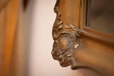 a close up of a wooden door with a mirror at Da Vinci Apartment in Kraków