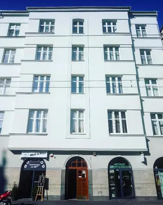 a white building with two doors and windows at Da Vinci Apartment in Kraków
