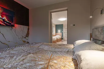 a bedroom with two beds and a mirror at Apartament Komfort przy Parku Zdrojowym in Rabka