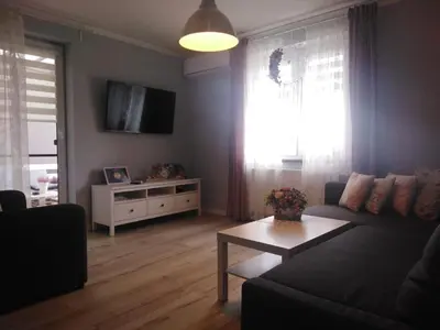a living room with a couch and a table at Apartament Antek klimatyzowany in Oświęcim