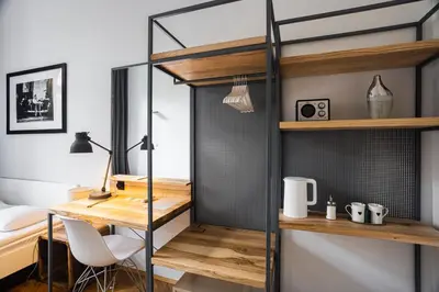 a room with a desk and a loft bed at Straszewskiego 24 Boutique Apartments in Kraków