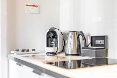 a coffeemaker sitting on a counter in a kitchen at Straszewskiego 24 Boutique Apartments in Kraków