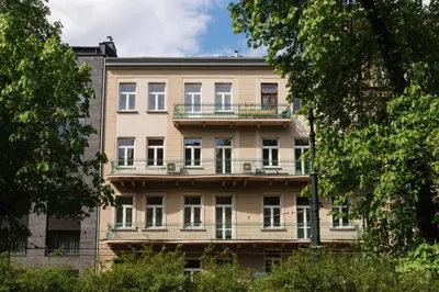 an apartment building with balconies and trees at Straszewskiego 24 Boutique Apartments in Kraków