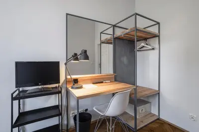 a desk with a computer and a monitor in a room at Straszewskiego 24 Boutique Apartments in Kraków