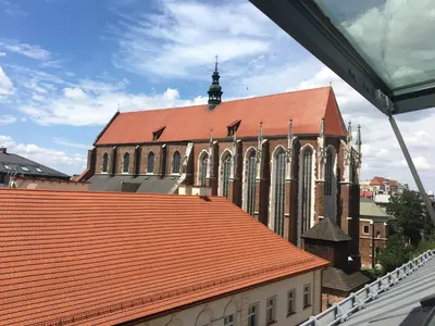 a large church with a large red roof at Central Penthouse with terrace in Kraków