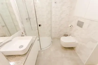 a white bathroom with a toilet and a sink at Central Penthouse with terrace in Kraków