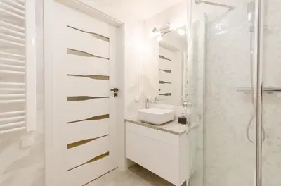 a white bathroom with a sink and a shower at Central Penthouse with terrace in Kraków