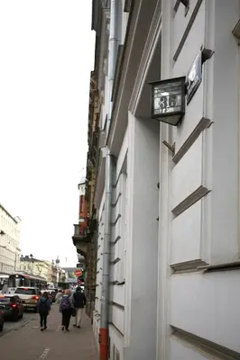 a sign on the side of a building on a street at AS Smart Apartment Old Town Krakow in Kraków