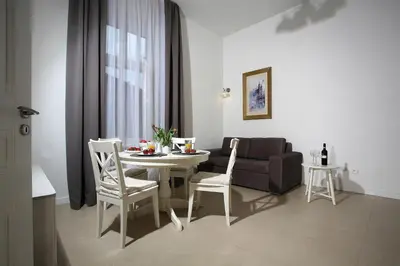 a living room with a table and chairs and a couch at AS Smart Apartment Old Town Krakow in Kraków