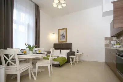 a kitchen and dining room with a table and chairs at AS Smart Apartment Old Town Krakow in Kraków
