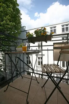a balcony with a table with plants on it at AS Smart Apartment Old Town Krakow in Kraków