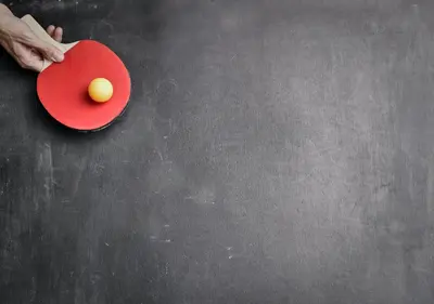 a persons hand holding a red plate with an egg on it at Hotel Alf in Kraków