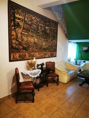 a living room with a table and chairs and a painting on the wall at Hotel Zabawa in Zabawa
