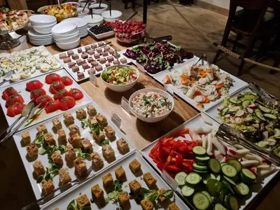 a table with many different types of food on it at Crystal Suites Chez Helena in Kraków