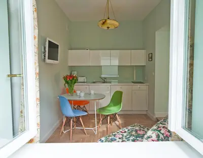 a kitchen with a table and four chairs at Crystal Suites Chez Helena in Kraków