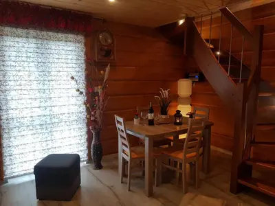 a dining room with a table and chairs and a staircase at Gniewnik in Pcim