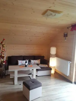 a living room with a couch and a table at Gniewnik in Pcim